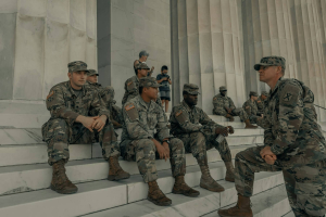 soldiers in combat uniform sitting on Lincoln Memorial steps
