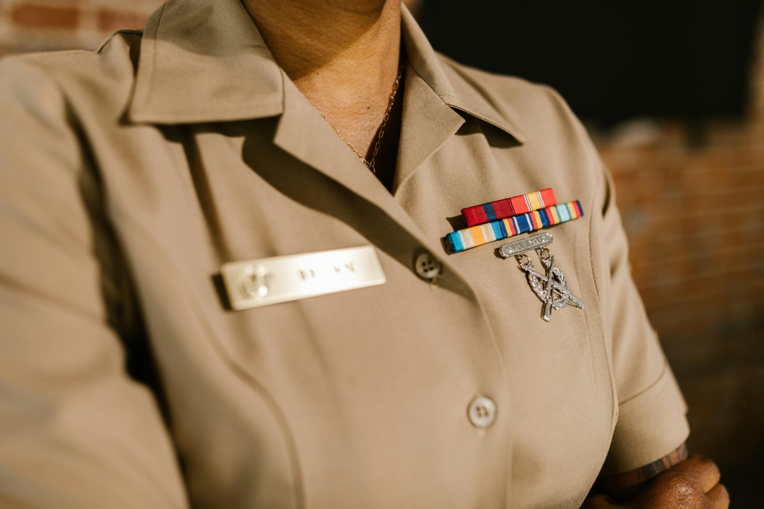 closeup of person in military uniform with insignia