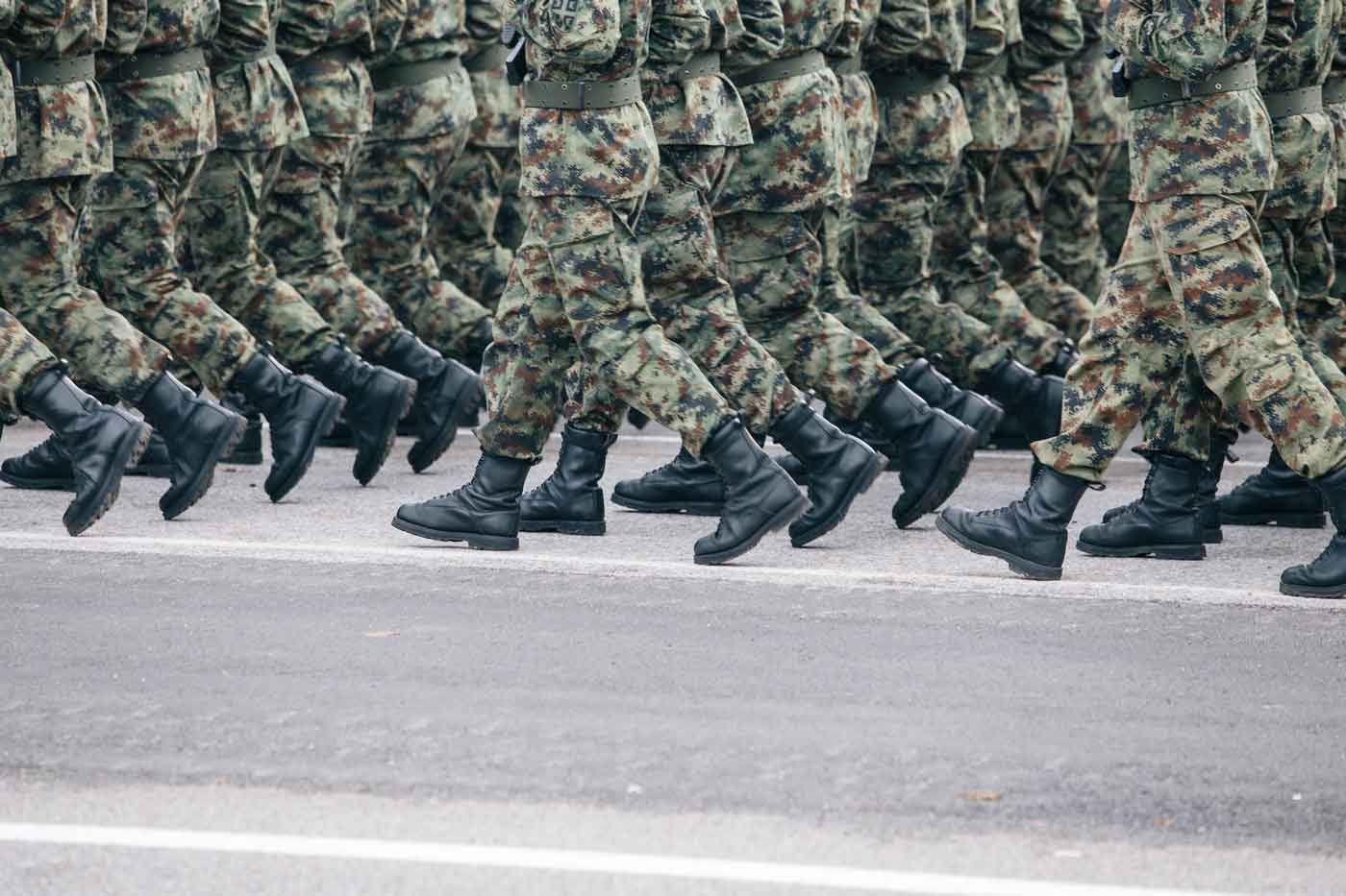 soldiers walking in military camo uniform and military boots