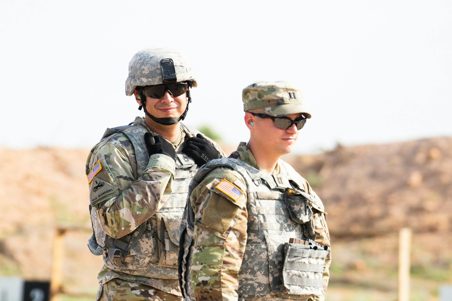 US soldiers in uniform wearing MOLLE vests outside